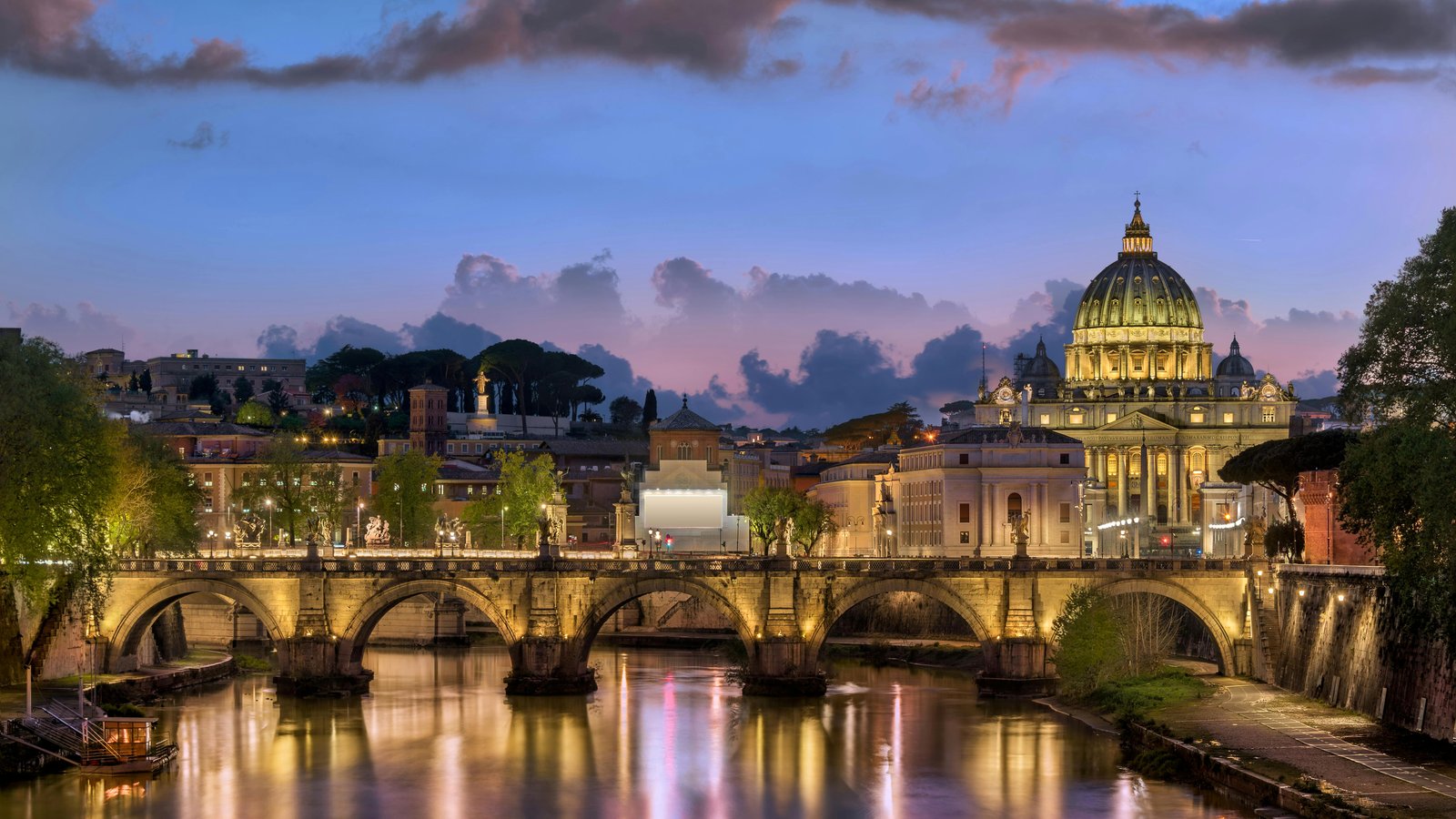 St. Peter’s Basilica and Ponte Sant’Angelo bridge at sunset in Rome, Italy